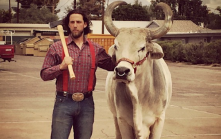 Madison Bumgarner In His Element Posing With an Ox