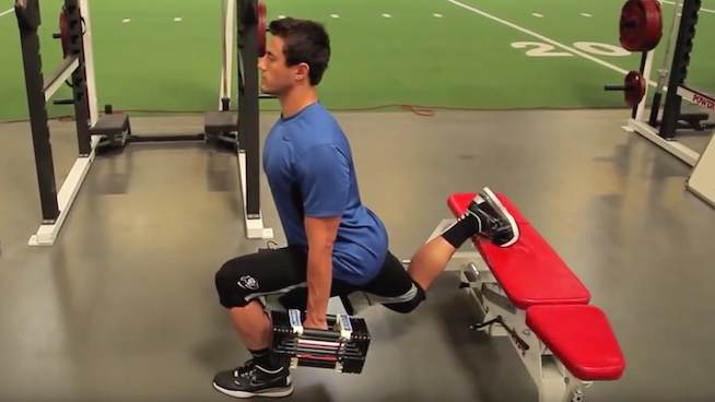 male performing single leg exercise at gym