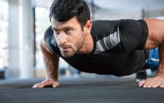 Man doing push ups in gym