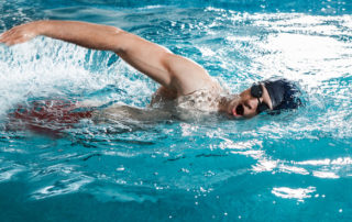 male swimmer swimming in pool