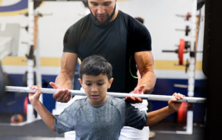 Trainer helps young athlete - STACK