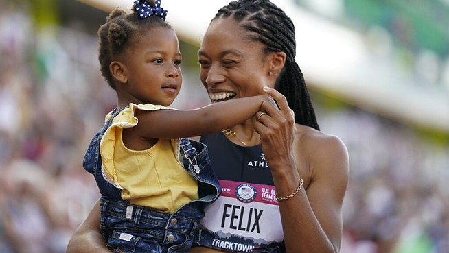 Allyson Felix celebrates after her second place finish in the women's 400-meter run with her daughter Camryn at the U.S. Olympic Track and Field Trials Sunday, June 20, 2021, in Eugene, Ore.(AP Photo/Ashley Landis)